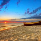 Sunset beach with fishing boat